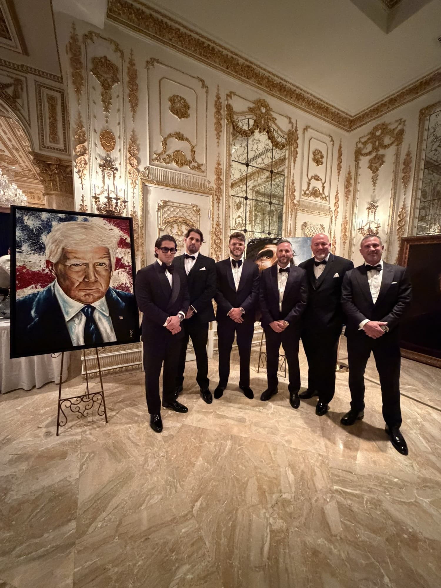 Damien Galvin at a formal event Damien Galvin (Shield / @Shieldmetax) with a group in tuxedos in a gilded formal hall